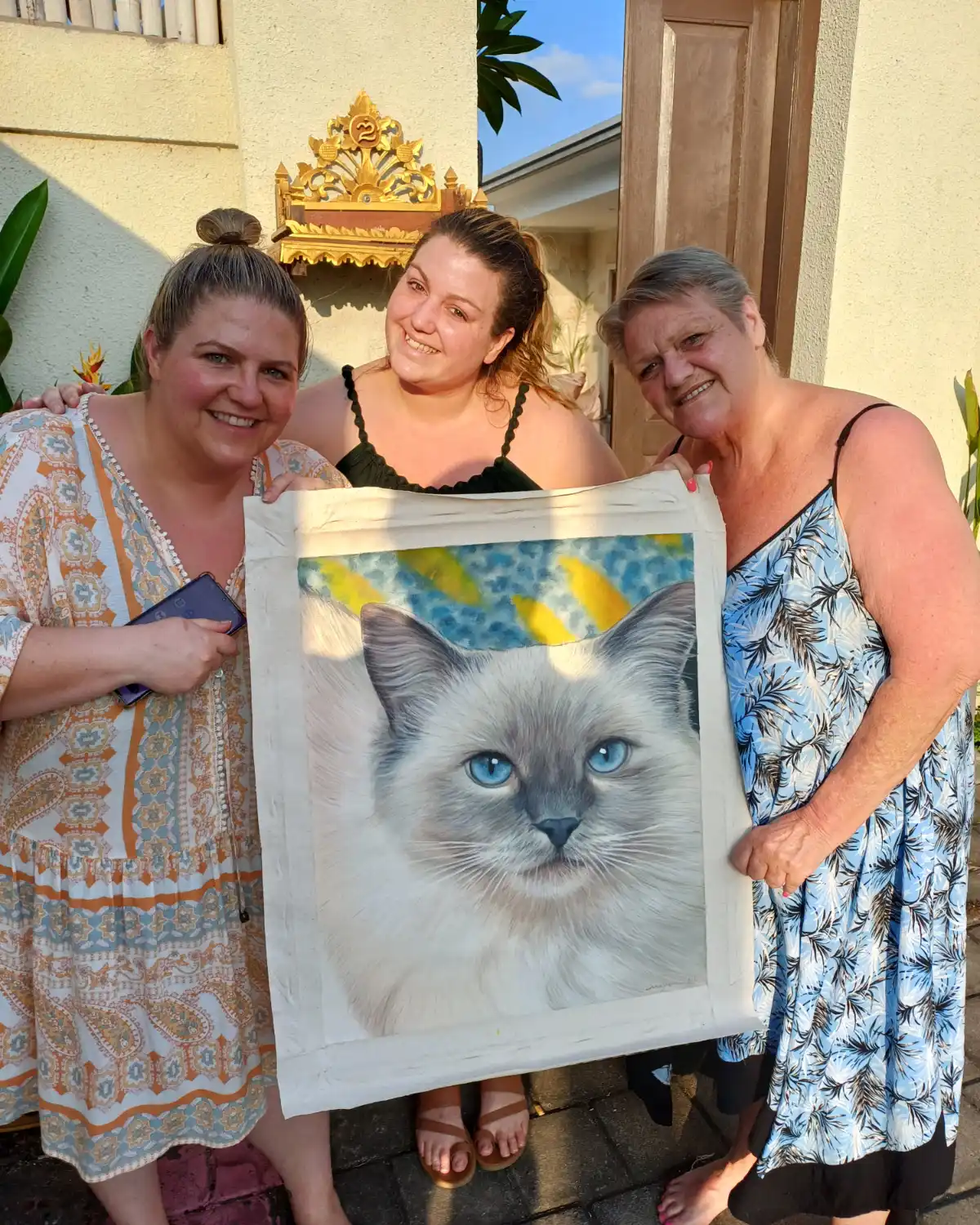 Happy art collector in Bali with finished portrait
